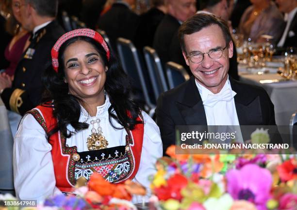 Swedish Prime Minister Ulf Kristersson and Norway's Culture and Equality Minister Lubna Jaffery attend the Nobel Prize Banquet at the City Hall in...