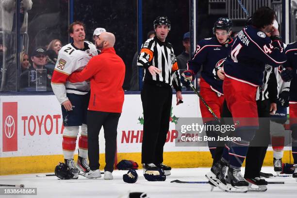 Nick Cousins of the Florida Panthers shares words with Erik Gudbranson of the Columbus Blue Jackets following a fight during the third period of a...