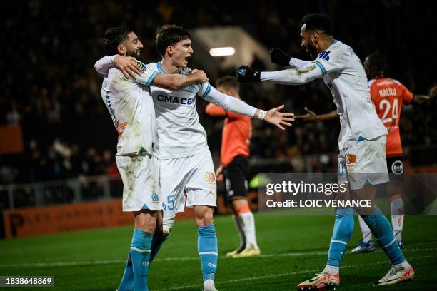 Marseille's Argentine defender Leonardo Balerdi celebrates with teammates after scoring a goal during the French L1 football match between FC Lorient...