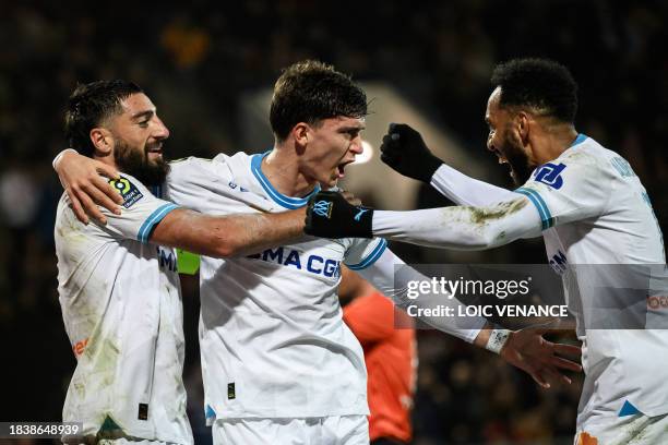 Marseille's Argentine defender Leonardo Balerdi celebrates with teammates after scoring a goal during the French L1 football match between FC Lorient...