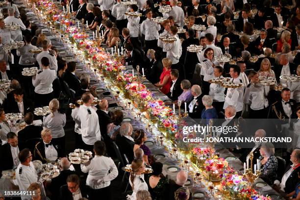 Waiters serve desserts during the Nobel Prize Banquet at the City Hall in Stockholm, Sweden on December 10 following the Nobel awards ceremony.