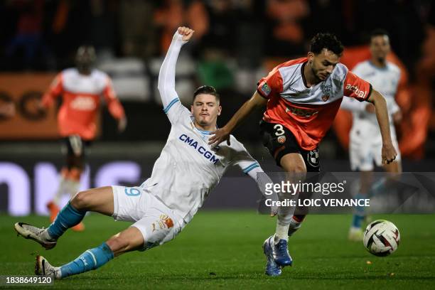 Lorient's Tunisian defender Montassar Talbi fights for the ball with Marseille's Portuguese forward Vitinha during the French L1 football match...