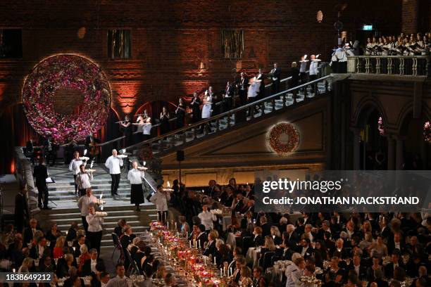 Waiters serve desserts during the Nobel Prize Banquet at the City Hall in Stockholm, Sweden on December 10 following the Nobel awards ceremony.