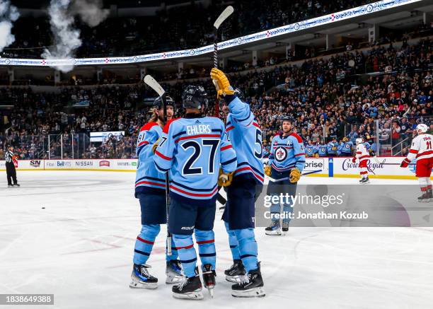 Nikolaj Ehlers, Mark Scheifele, Kyle Connor, and Josh Morrissey of the Winnipeg Jets celebrate a second period goal against the Carolina Hurricanes...