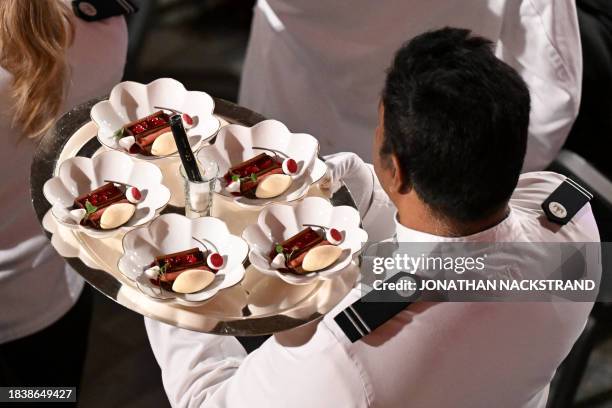 Waiter carries a tray with desserts during the Nobel Prize Banquet at the City Hall in Stockholm, Sweden on December 10 following the Nobel awards...