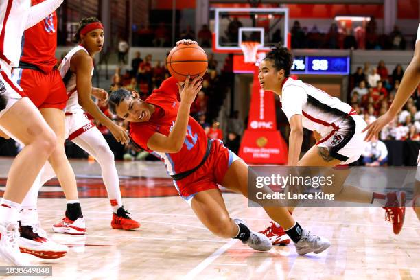 Asia Boone of the Liberty Lady Flames slips with the ball during the second half of the game against the NC State Wolfpack at Reynolds Coliseum on...