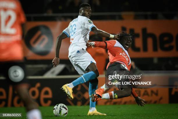 Marseille's Congolese defender Chancel Mbemba fights for the ball with Lorient's Senegalese forward Bamba Dieng during the French L1 football match...