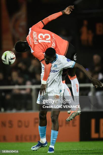 Lorient's Senegalese defender Formose Mendy fights for the ball with Marseille's Senegalese forward Ismaila Sarr during the French L1 football match...