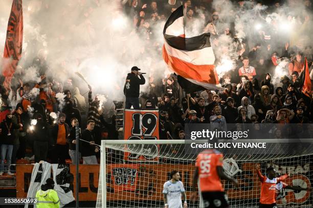 Lorient's supporters cheer during the French L1 football match between FC Lorient and Olympique de Marseille at the Moustoir stadium on December 10,...