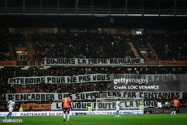 Lorient's supporters cheer during the French L1 football match between FC Lorient and Olympique de Marseille at the Moustoir stadium on December 10,...