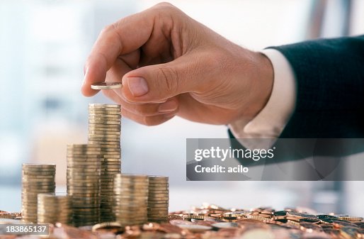 Businessman is stacking coins Businessman is stacking coins