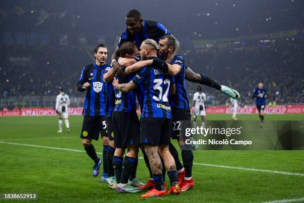 Hakan Calhanoglu of FC Internazionale celebrates with teammates after scoring the opening goal from a penalty kick during the Serie A football match...