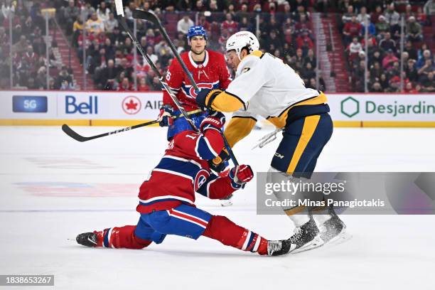 Jeremy Lauzon of the Nashville Predators takes down Brendan Gallagher of the Montreal Canadiens during the second period at the Bell Centre on...