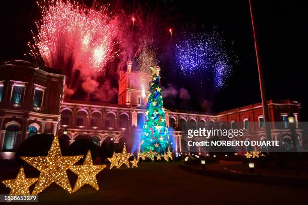 Fireworks go off as a big Christmas tree is illuminated at Lopez Presidential Palace in Asuncion to announce the start of the Christmas celebrations...