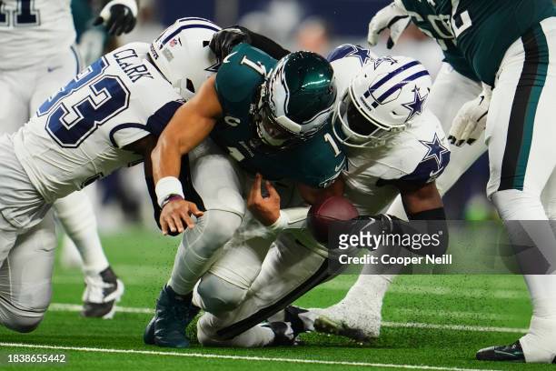 Jalen Hurts of the Philadelphia Eagles fumbles the ball against the Dallas Cowboys during the first half at AT&T Stadium on December 10, 2023 in...