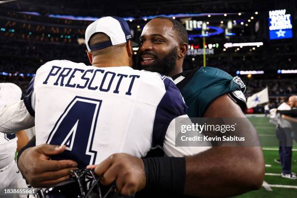 Dak Prescott of the Dallas Cowboys hugs Fletcher Cox of the Philadelphia Eagles after an NFL football game at AT&T Stadium on December 10, 2023 in...