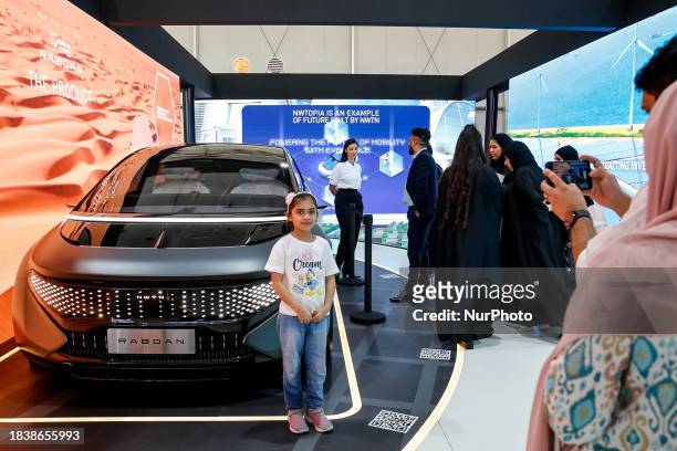 Participants watch a prototype of hydrogen fueled car, Rabdan, made in UAE in the conference venue, Technology and Innovation Pavilion, Green Zone...