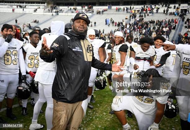 Freedom head coach Darryl Overton reacts to getting a water bath after the Freedom Eagles' defeat of the Highland Springs Springers 42-34 to win the...