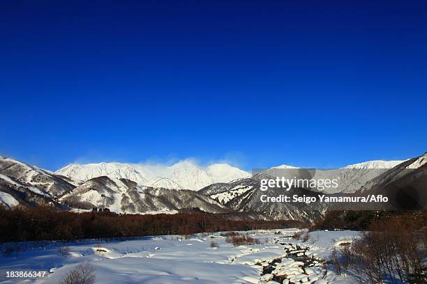 mountains covered in snow and blue sky in hakuba, nagano prefecture - hakuba fotografías e imágenes de stock