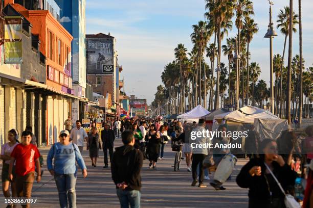 People enjoy at the Venice Beach during sunset as daily life in Pacific coastline of Los Angeles, California, United States on December 10, 2023.