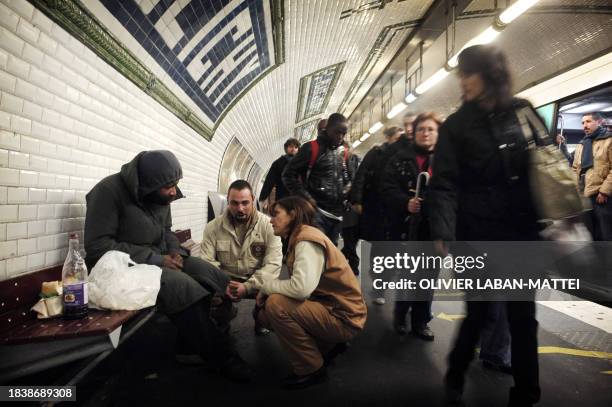 Social workers of the RATP , speak with a homeless man on a platform at the subway station Place de Clichy to convince him to take the RATP social...