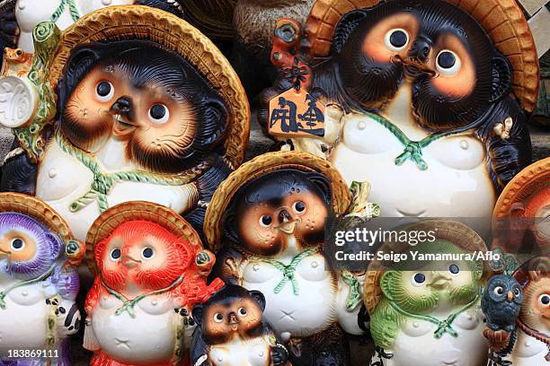 japanese traditional raccoon statues - tanuki stock pictures, royalty-free photos & images