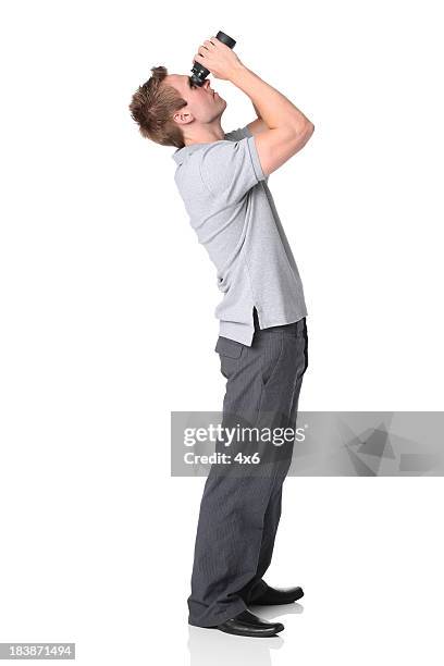 man looking through binoculars - looking through binoculars stock pictures, royalty-free photos & images