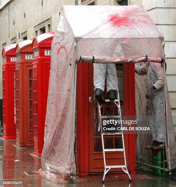 British red telephone box is repainted and in London, April 26, 2005. Even with mobile phone owned by most Londoners, the familiar red phone box...