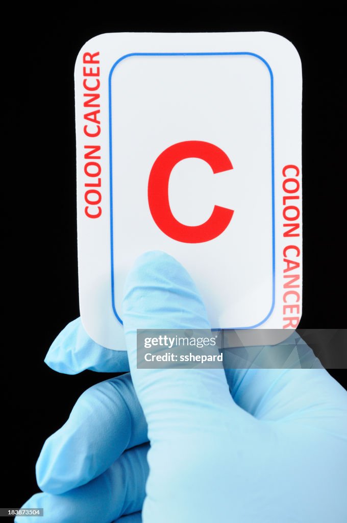 Colon cancer card and latex glove