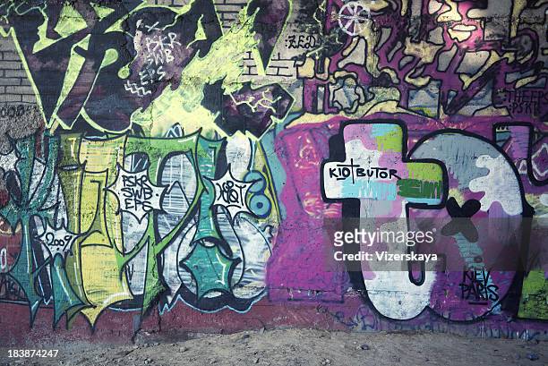 graffiti at the wall - graffiti wall stock illustrations
