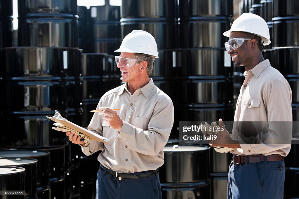 Manufacturing workers by steel drums
