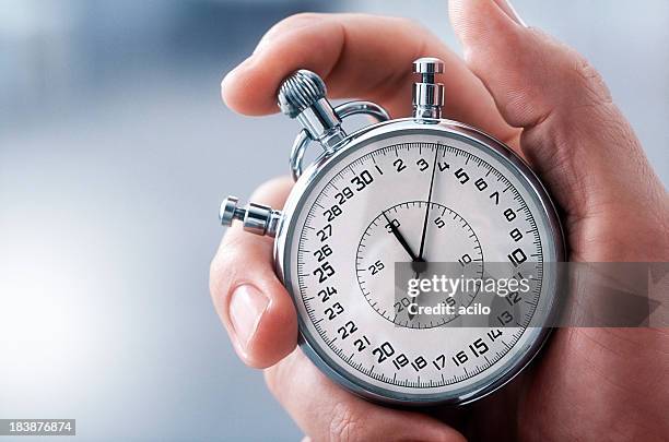 hand with classic stopwatch - startstreep stockfoto's en -beelden