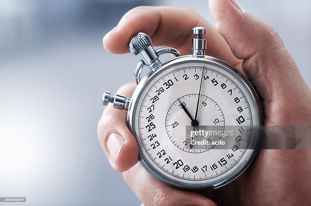 Hand with classic stopwatch