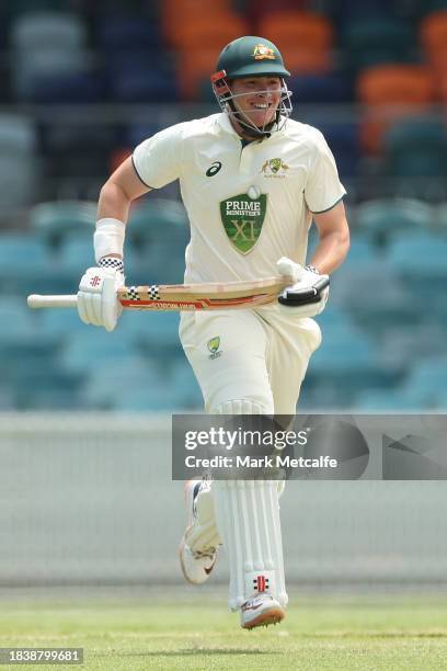 Matthew Renshaw of the Prime Ministers XI runs between wickets to make his half century during day three of the Tour Match between PM's XI and...