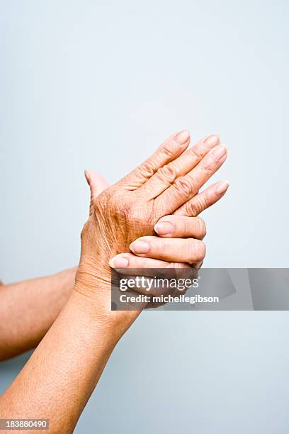 elderly woman's with arthritis in her hands - arthritic hands stock pictures, royalty-free photos & images