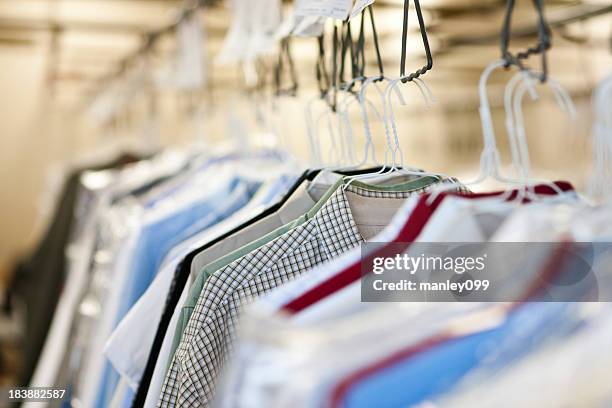 clothes at a dry cleaners - dry cleaners stock pictures, royalty-free photos & images