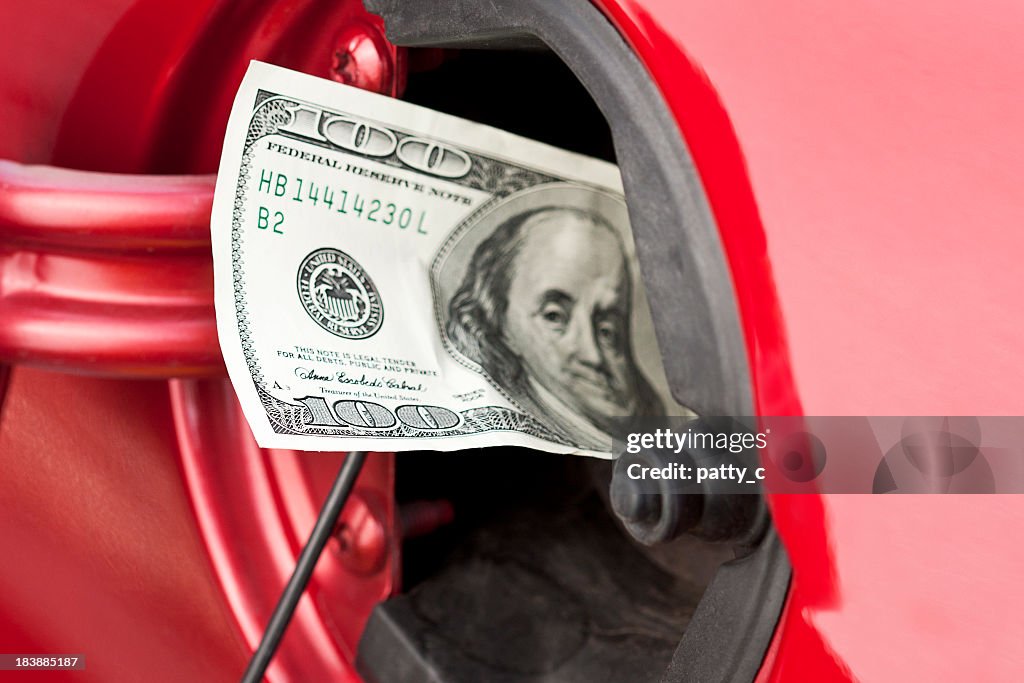 A hundred dollar bill stuffed into a cars gas tank