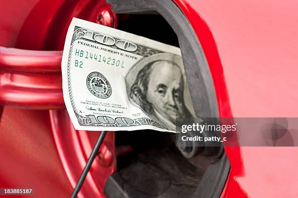 a hundred dollar bill stuffed into a cars gas tank - premium gasoline stock pictures, royalty-free photos & images