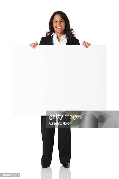 smiling businesswoman holding up sign - mexican posters stock pictures, royalty-free photos & images