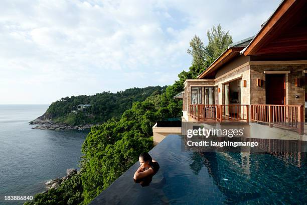 a woman in a oil overlooking phuket, thailand - beach house 個照片及圖片檔