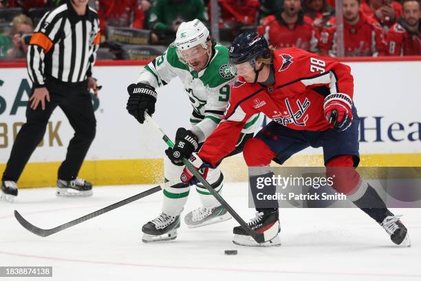 Matt Duchene of the Dallas Stars and Rasmus Sandin of the Washington Capitals battle for the puck during the first period at Capital One Arena on...