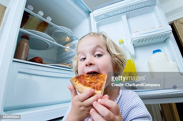 young girl eating cold pizza from the fridge - funny fridge stock pictures, royalty-free photos & images