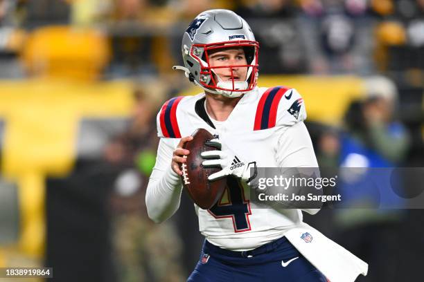 Quarterback Bailey Zappe of the New England Patriots looks to pass in the first half against the Pittsburgh Steelers at Acrisure Stadium on December...