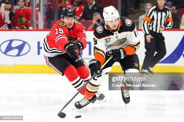 Joey Anderson of the Chicago Blackhawks and Troy Terry of the Anaheim Ducks battle for control of the puck during the first period at the United...