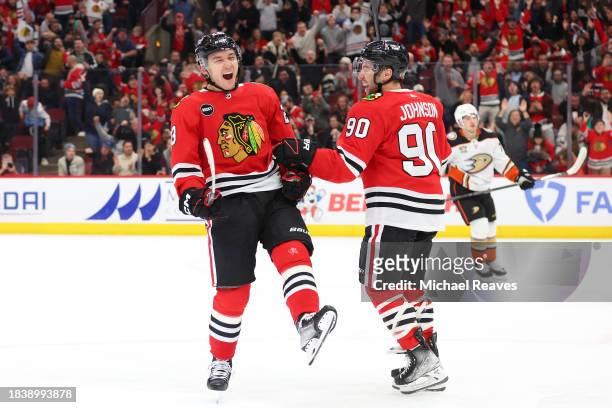 Philipp Kurashev of the Chicago Blackhawks celebrates with Tyler Johnson after scoring a goal against the Anaheim Ducks during the second period at...