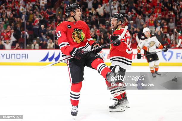 Philipp Kurashev of the Chicago Blackhawks celebrates with Tyler Johnson after scoring a goal against the Anaheim Ducks during the second period at...