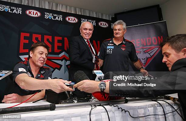 New Bombers coach Mark Thompson reacts next to Chairman Paul Little and new Senior assistant coach Neil Craig when getting his mobile phone handed...