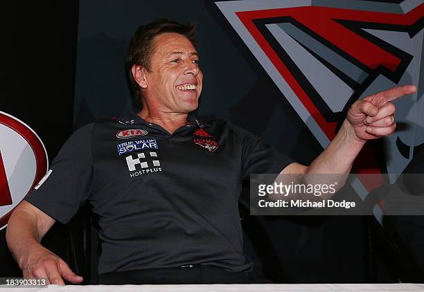 New Bombers coach Mark Thompson reacts after dropping his mobile phone during an Essendon Bombers AFL press conference at Windy Hill on October 10,...