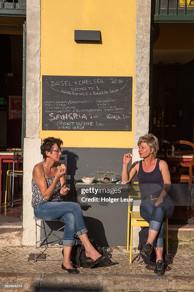 Two women outside Vardepedo restaurant in Alfama