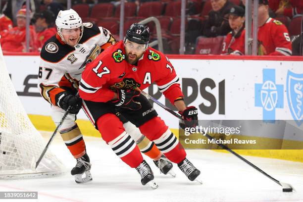 Nick Foligno of the Chicago Blackhawks skates with the puck against Tristan Luneau of the Anaheim Ducks during the second period at the United Center...